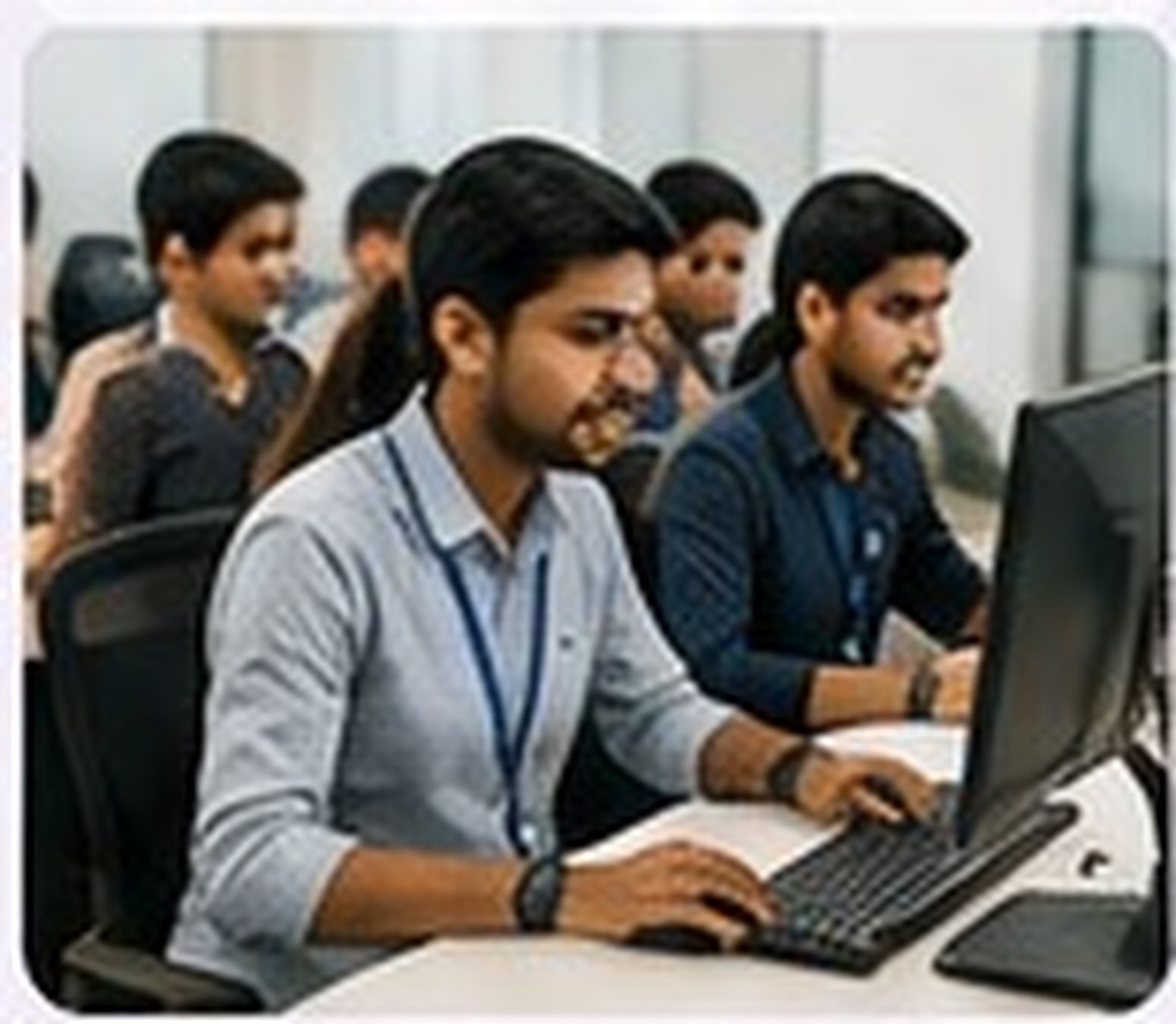 Professional IT training classroom with students learning software technologies
